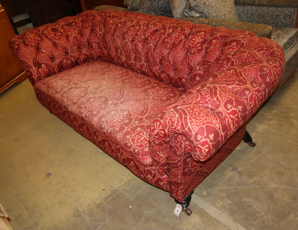 A late Victorian Chesterfield settee upholstered in buttoned red fabric, W.200cm, D.94cm, H.68cm